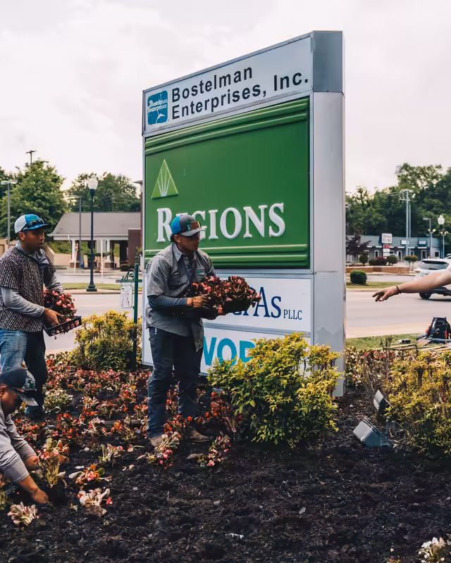 Richardson crew planting seasonal color around a downtown Columbia sign