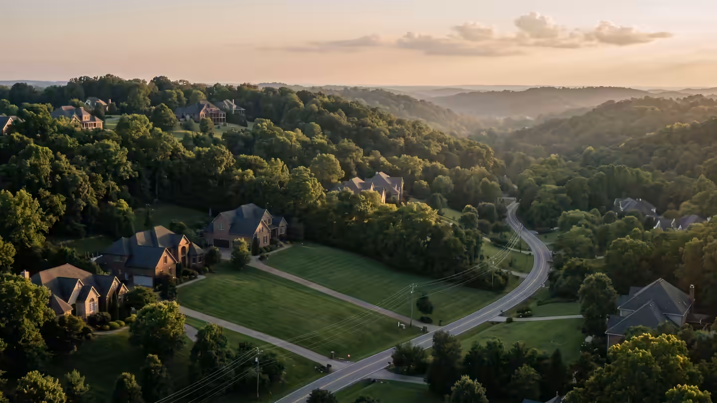 Wooded hills and large homes on big lots south of Nashville at sunset