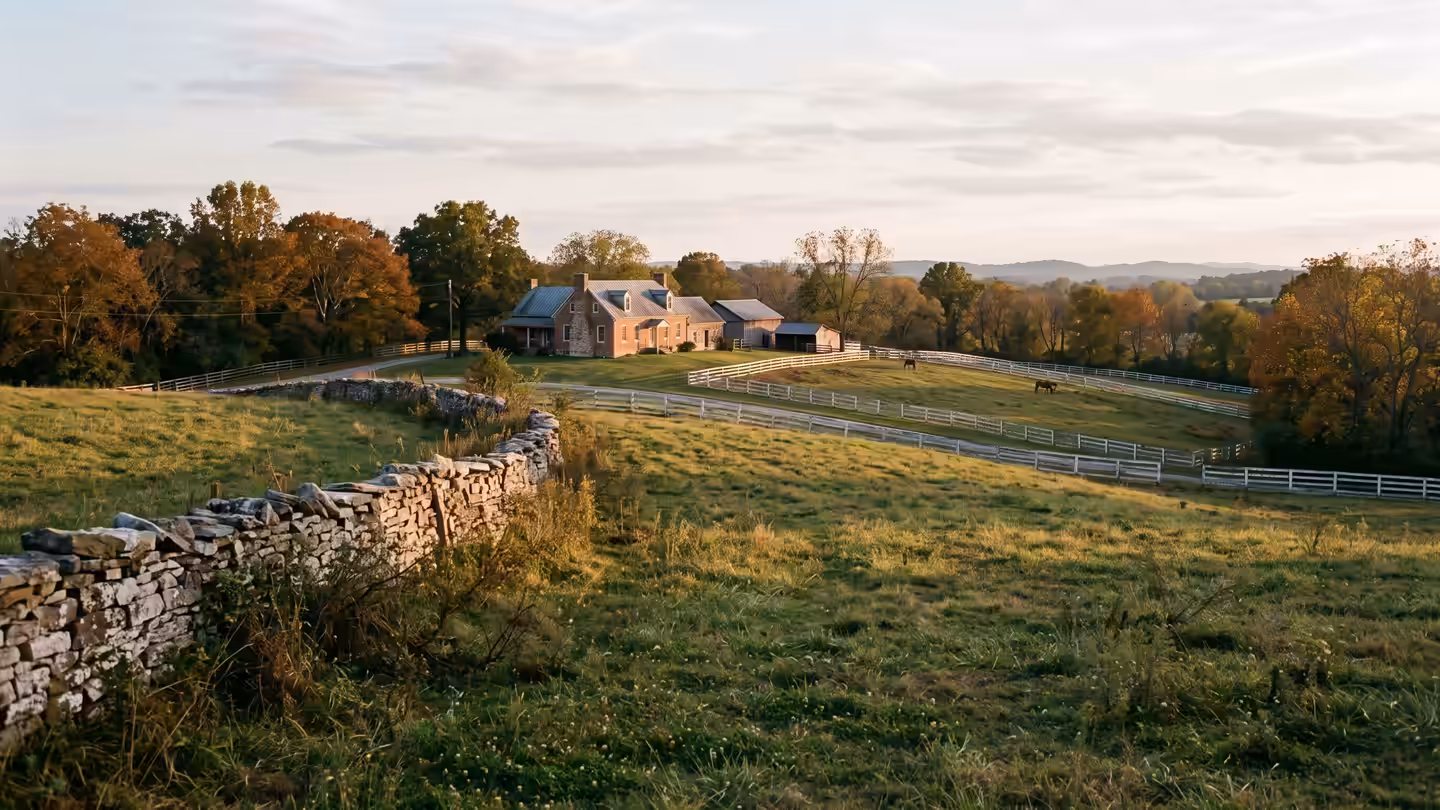 A dry-stacked stone wall and a horse farm on a Williamson County hillside in early autumn
