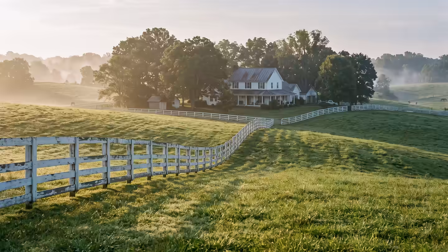 Rolling pasture and a white board fence, the open country around Thompson's Station