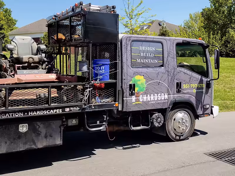 Richardson crew truck with mowers on the rack, lettered Design, Build, Maintain