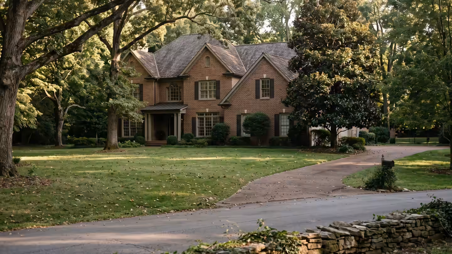 An established street with mature oaks and deep lawns, typical of Brentwood