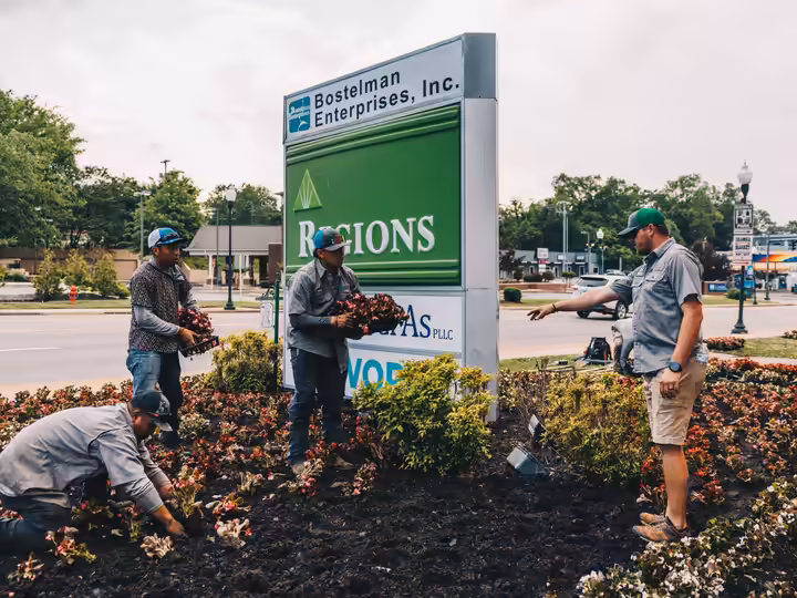 Richardson crew planting seasonal color around a downtown Columbia sign