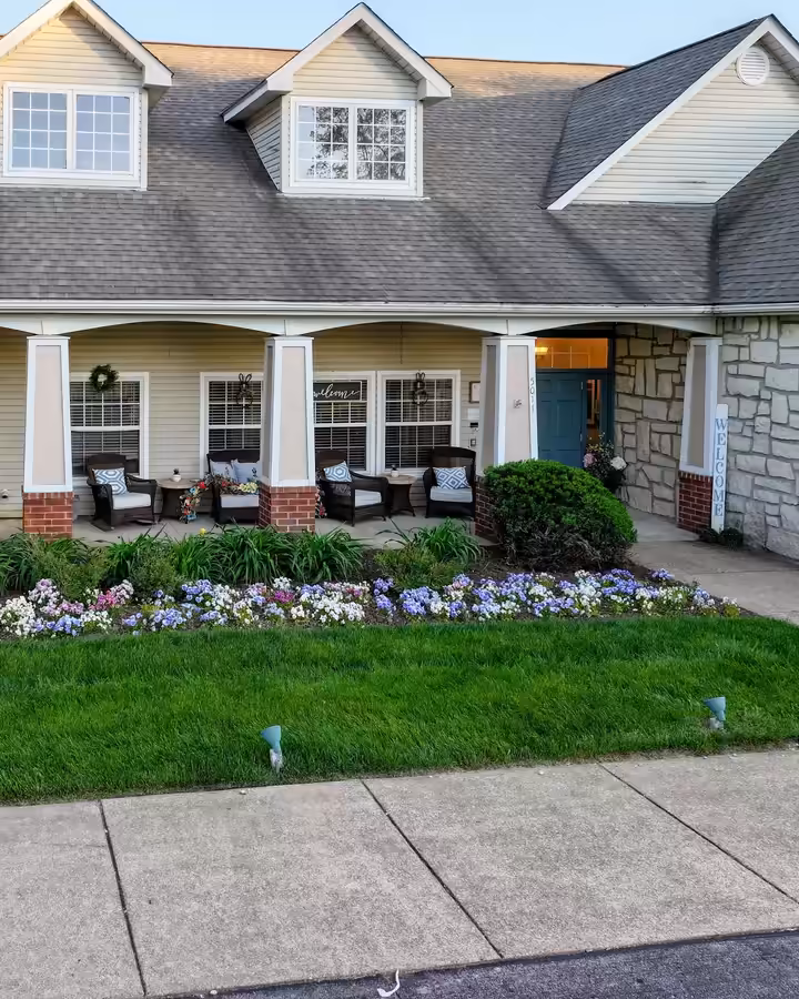 Hydrangeas and fresh flower beds along a porch at Brookdale Columbia