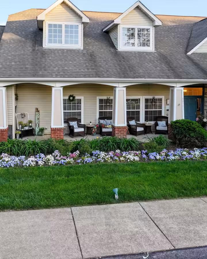 Freshly planted hydrangeas and flower beds along a porch at Brookdale Columbia