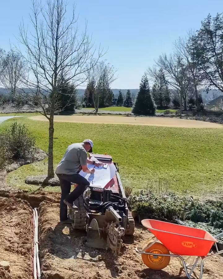 Richardson designer reviewing a landscape plan with a homeowner on site