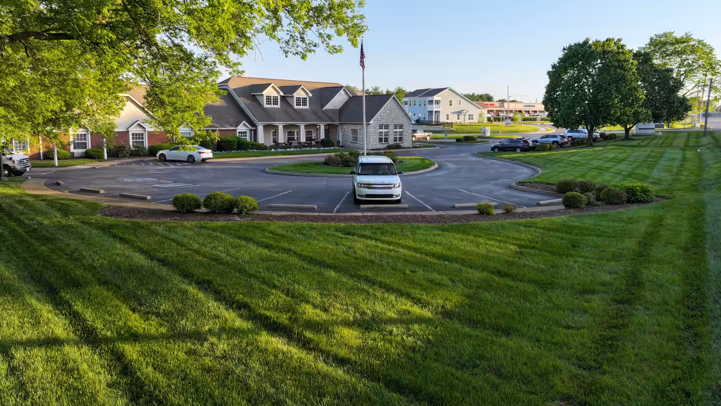 Freshly striped lawn and trimmed shrubs around the circle drive at Brookdale Columbia