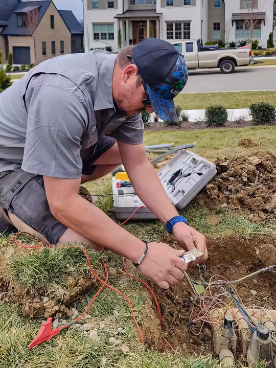 Irrigation technician wiring a valve box